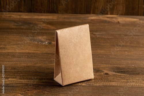 Kraft cardboard box on wooden background, moke up