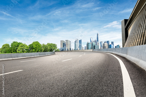 Asphalt road and modern city commercial building scenery in Shanghai