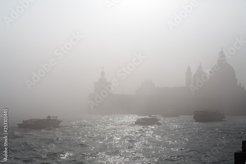 Quay of San Marco and the lagoon in the fog of Venice