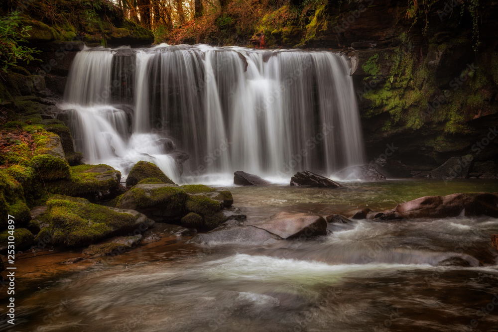 Fototapeta premium Cwmdu waterfall on The Upper Clydach River which runs through the town of Pontardawe in the Swansea Valley, South Wales.