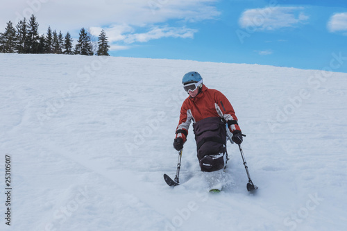Fotografie handicapped athlete goes downhill skiing, disabled skier and  disability snow sp