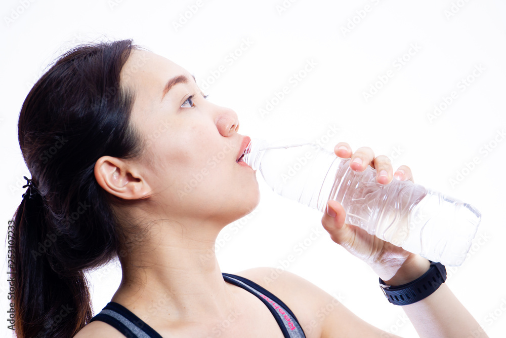 Beautiful Asian sport women drinking water in bottle close up on white background. Beautiful Asian sport women drinking water in bottle close up on white background.