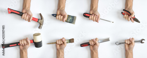 Various working tools in hand on white background.