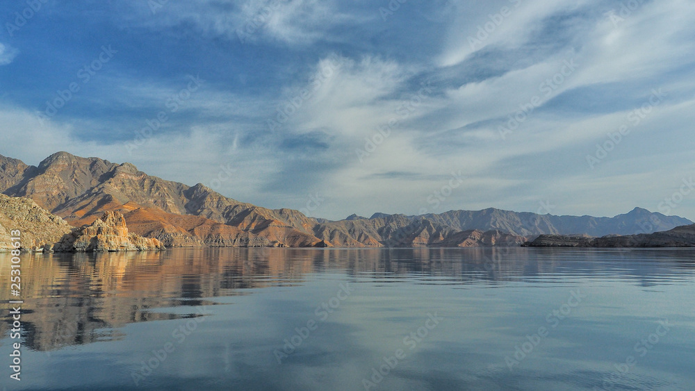 Beautiful mountains reflected in the water. Fjords on the Musandam peninsula. Khasab. Oman