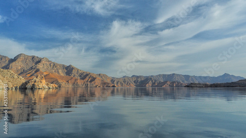 Beautiful mountains reflected in the water. Fjords on the Musandam peninsula. Khasab. Oman photo