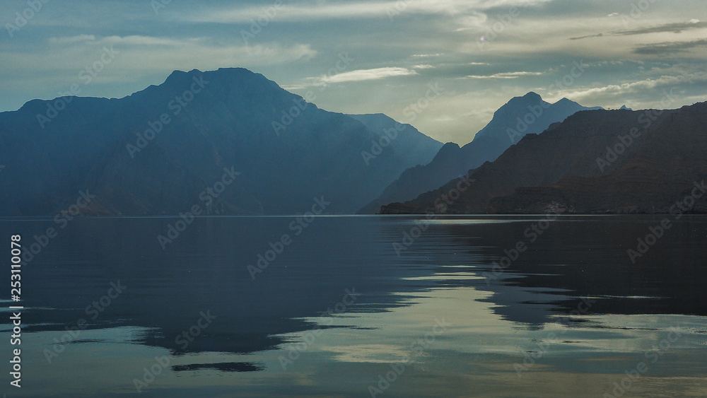 Beautiful mountains reflected in the water. Fjords on the Musandam peninsula. Khasab. Oman