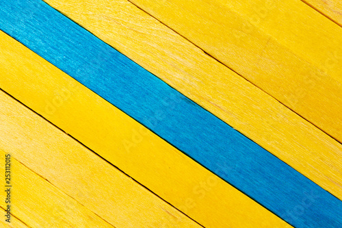 Yellow diagonal colored wooden background with aquamarine stripe