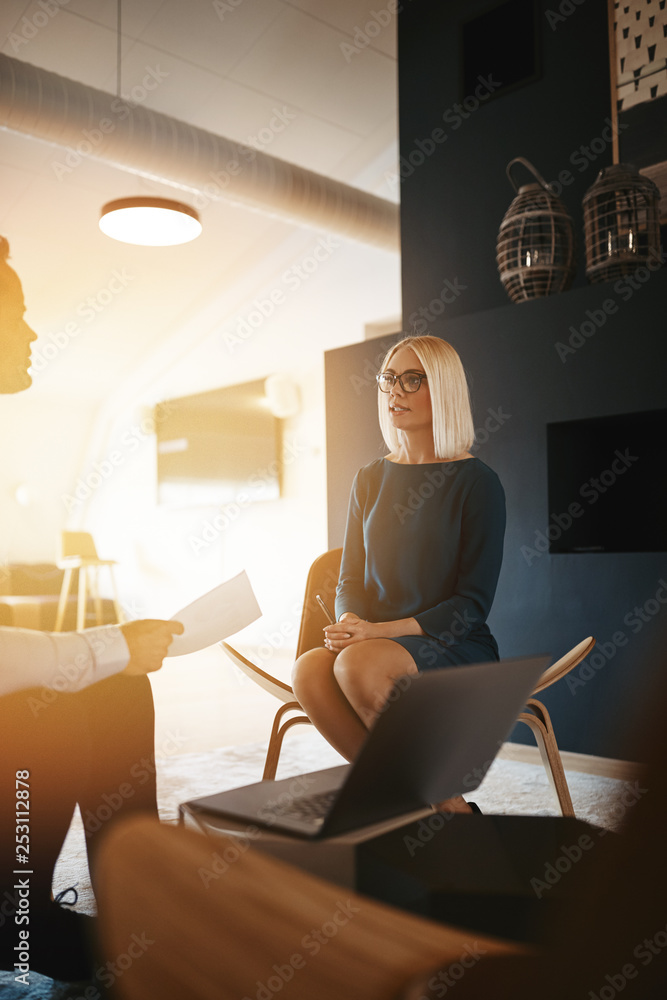 Two young businesspeople discussing work together in an office Two young businesspeople discussing work together in an office