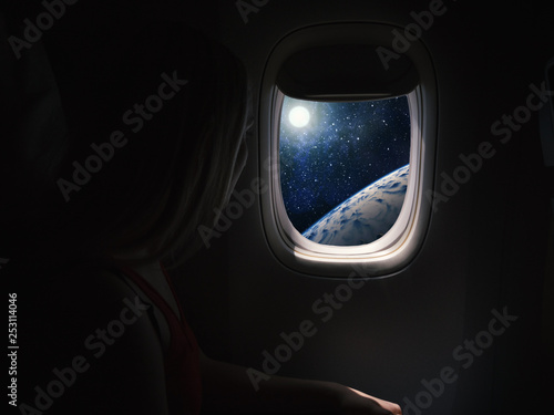 Принти на полотні Woman in spaceship looks out the porthole