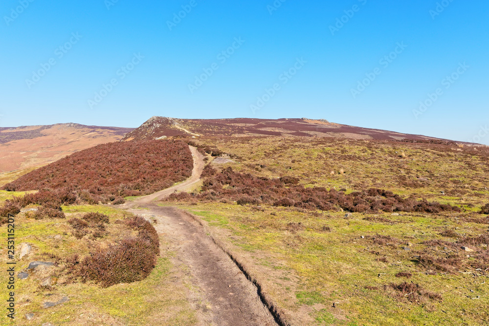 Narrow footpath winds up Derwent Moor in the Derbyshire Peak District.