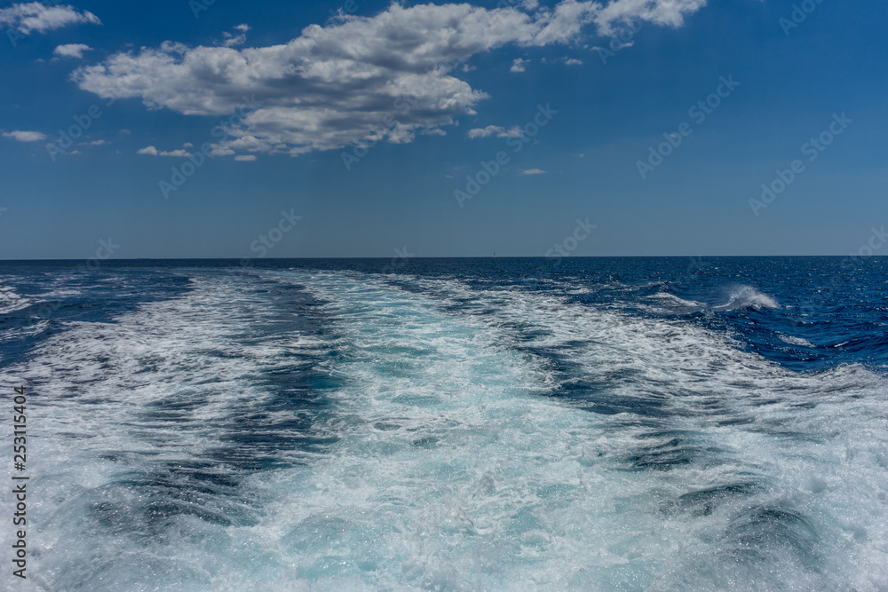 Italy, Cinque Terre, Monterosso, a man riding a wave in the ocean