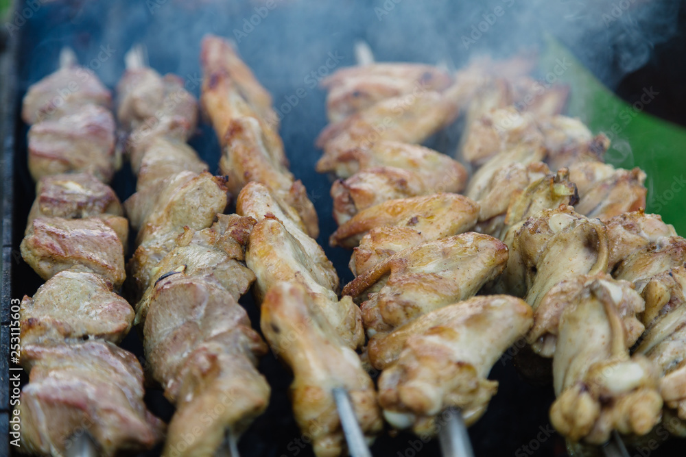 Shish kebab on skewers is fried on coals, juicy meat.