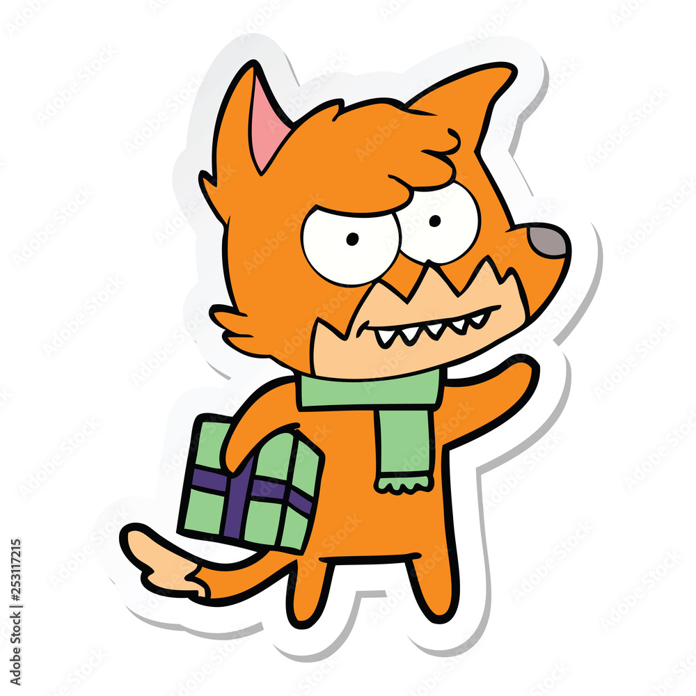 sticker of a cartoon grinning fox with christmas present sticker of a cartoon grinning fox with christmas present