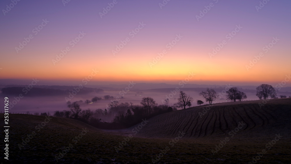 Misty morning sunrise over the Hambledon valley, Hampshire, UK