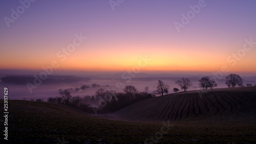 Misty morning sunrise over the Hambledon valley, Hampshire, UK photo