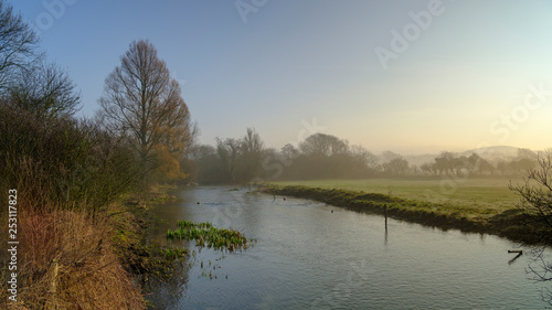 Misty morning light on the River Meon near Exton, South Downs National Park, Hampshire, UK