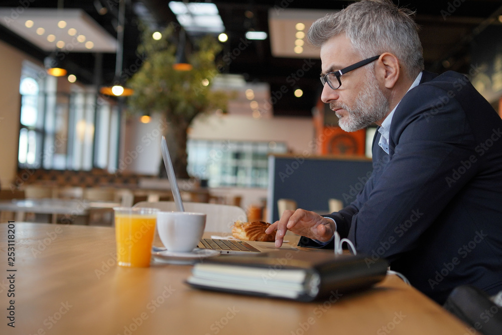 Businessman working in modern office cafeteria Businessman working in modern office cafeteria