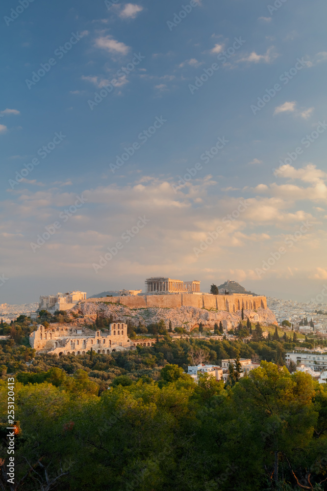 Vertical view on the Acropolis in Athens at sunrise. Scenic travel background with dramatic clouds. Greece