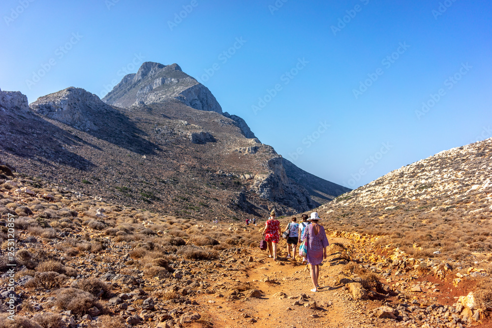 Tourists descend from the mountains to the beach of Balos in Crete, Greece