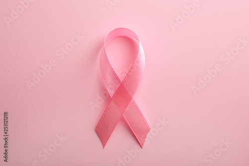 Pink ribbon on color background, top view. Breast cancer awareness concept