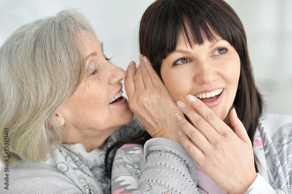 Portrait of beautiful senior woman whispering secret Portrait of beautiful senior woman whispering secret