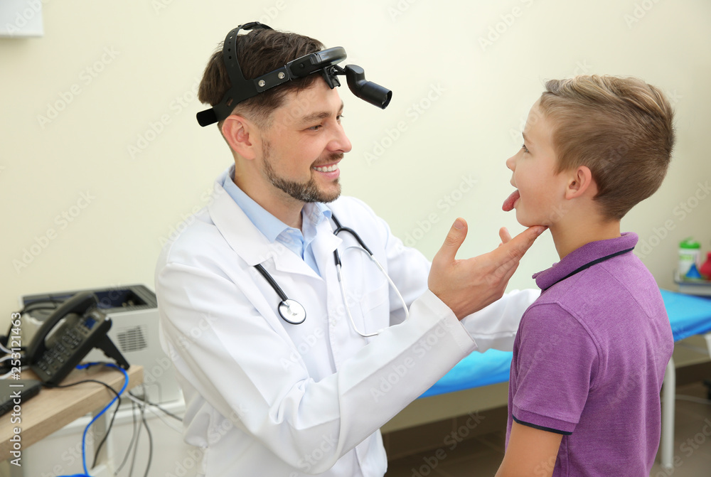 Male otolaryngologist examining little child in hospital Male otolaryngologist examining little child in hospital