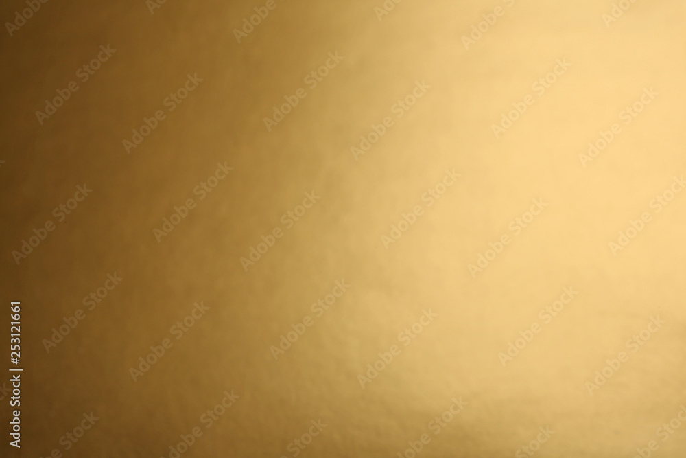 Blurred view of plain golden surface as background Blurred view of plain golden surface as background