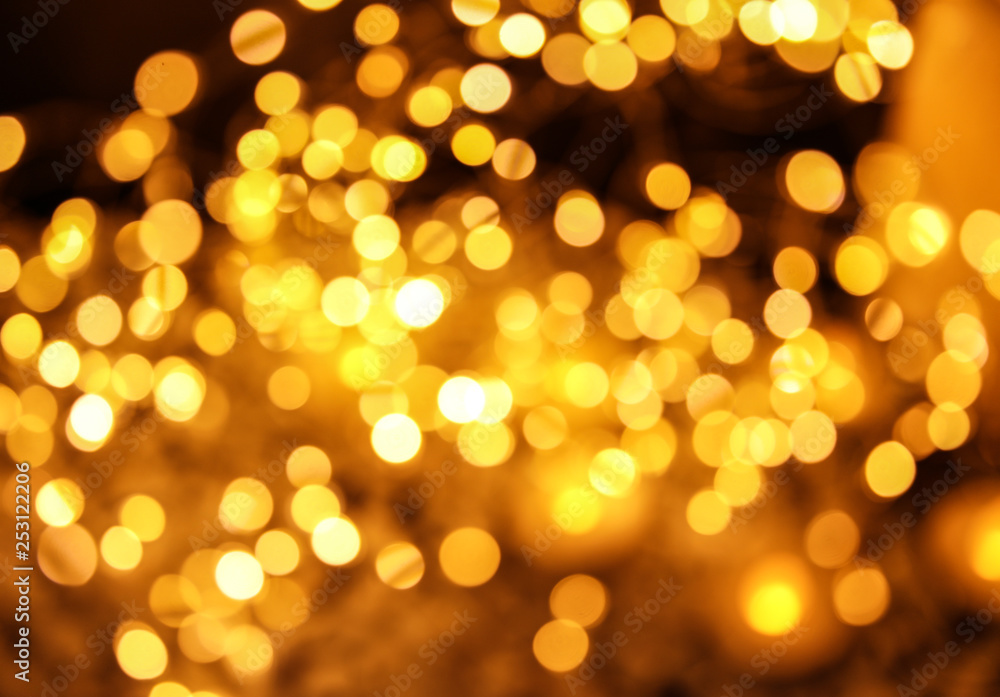 Gold glitter with bokeh effect on dark background Gold glitter with bokeh effect on dark background