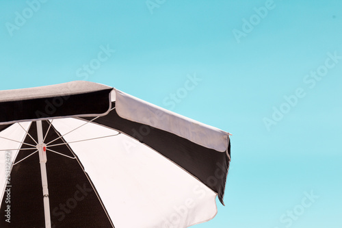 Black and White umbrella in the summer blue sky