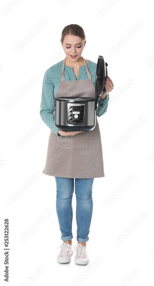 Full length portrait of young woman with modern multi cooker on white background Full length portrait of young woman with modern multi cooker on white background