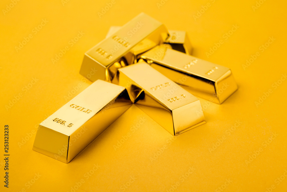 Precious shiny gold bars on color background Precious shiny gold bars on color background