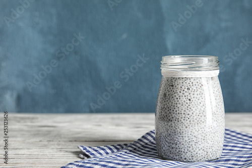 Jar of tasty chia seed pudding on table. Space for text
