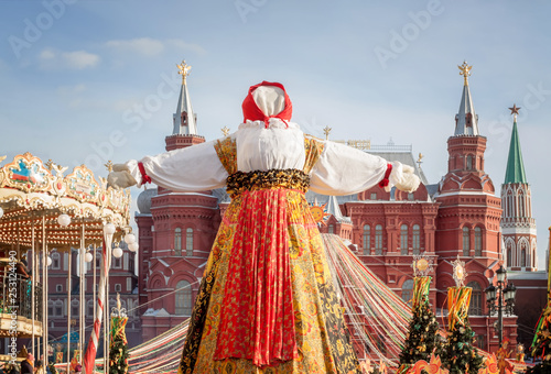 Manezhnaya Square in the center of Moscow, decorated with festive symbols of the Shrovetide in the form of the sun, colorful ribbons and garlands. Trade rows stand against the Kremlin walls .