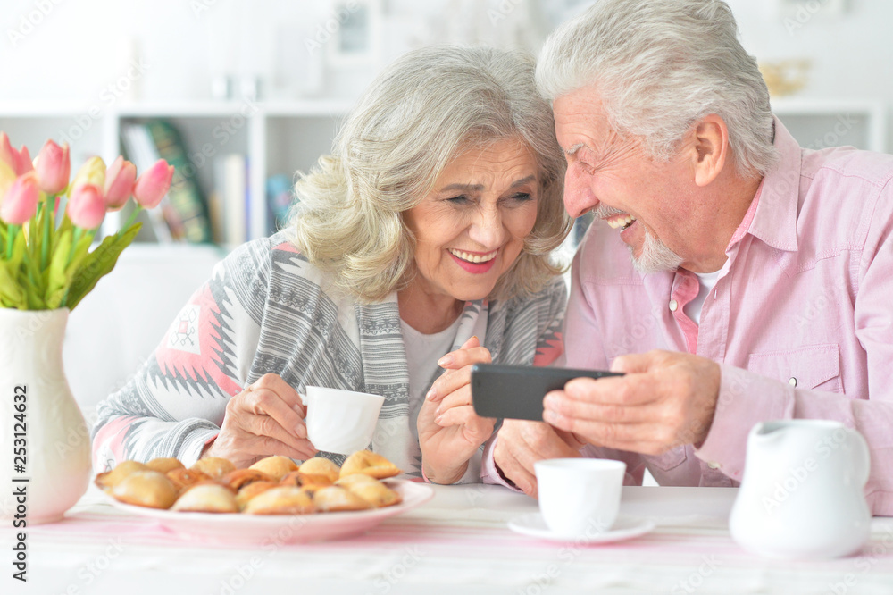 Portrait of happy senior couple looking at smartphone Portrait of happy senior couple looking at smartphone