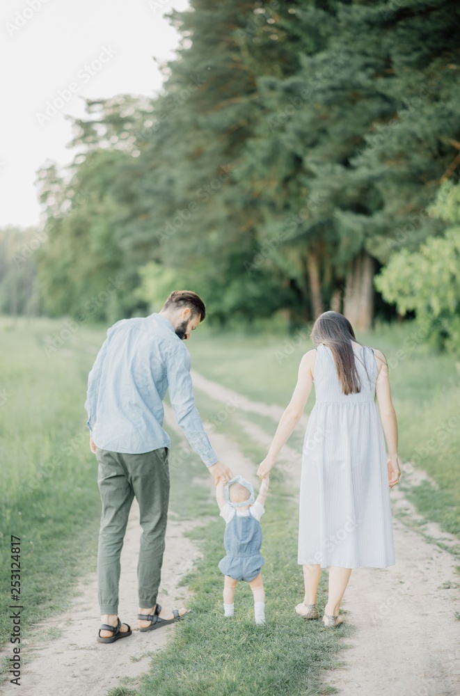 Happy young family spending time together outside in green nature Happy young family spending time together outside in green nature