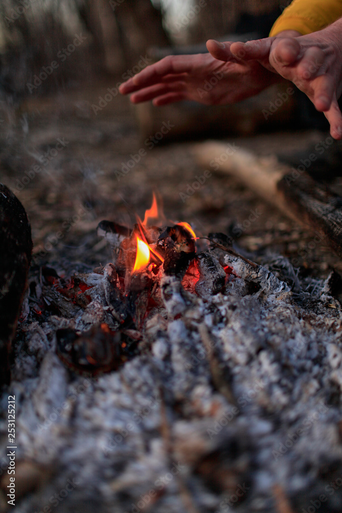 The hands of the person at the fire in the forest The hands of the person at the fire in the forest