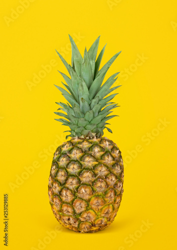 Pineapple against yellow background. Isolated.