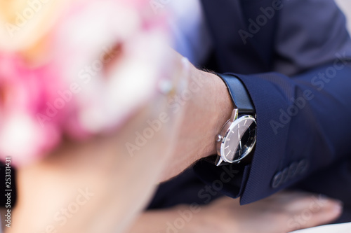 Young couple man and a woman after the wedding in a love photo session in the park on a bench.