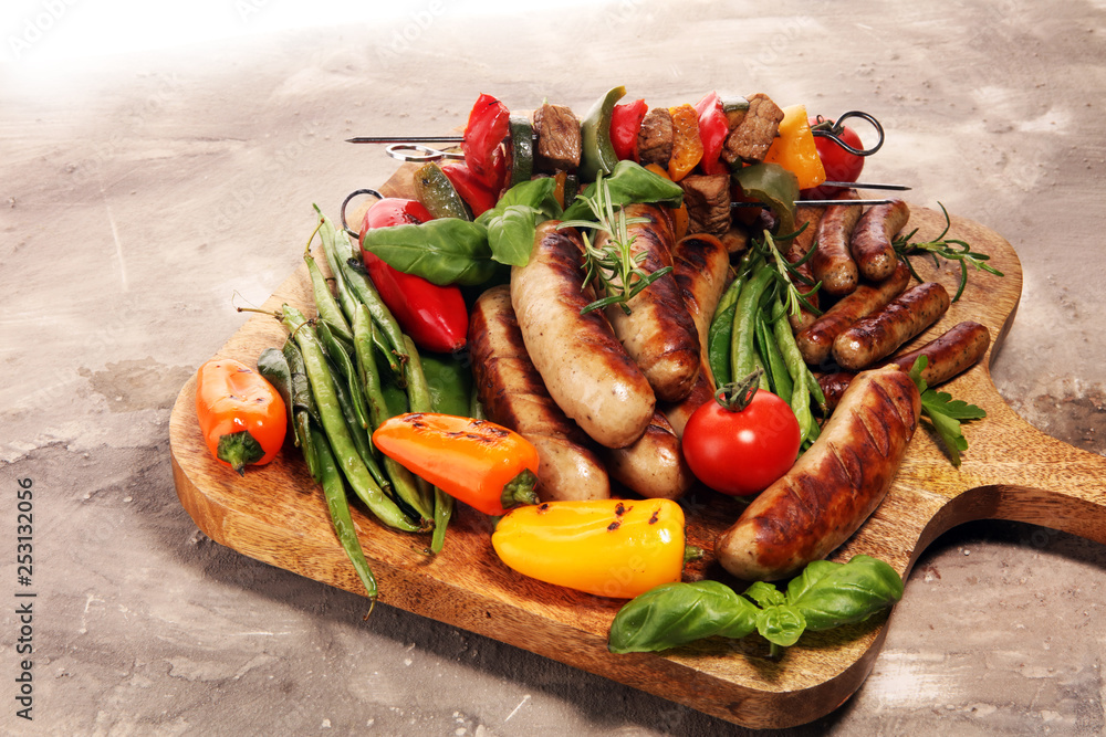 Assorted delicious grilled meat with vegetable on a barbecue. Grilled pork shish or kebab on skewers with vegetables . Food background shashlik Assorted delicious grilled meat with vegetable on a barbecue. Grilled pork shish or kebab on skewers with vegetables . Food background shashlik