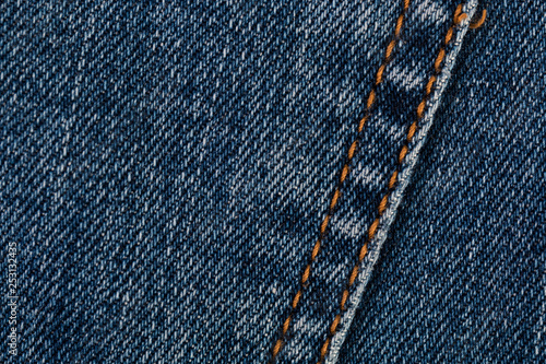 Blue jeans texture closeup. Denim with seam background.