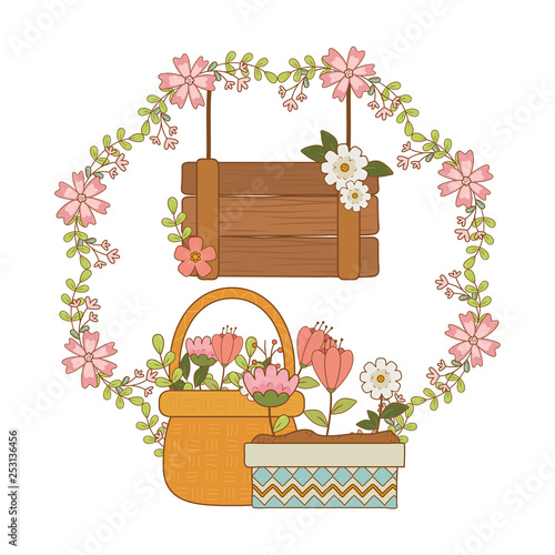 beautiful flowers in pot and basket with wooden label