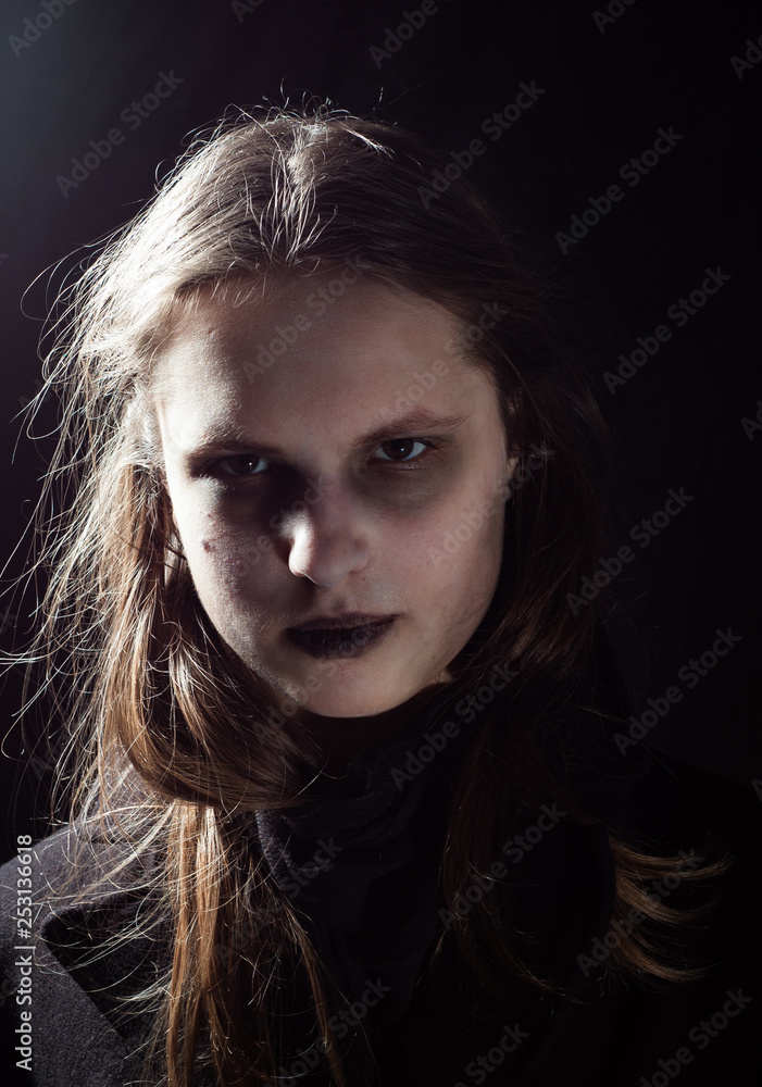 portrait of young teenager brunette girl with long hair in the Gothic style, on a black background portrait of young teenager brunette girl with long hair in the Gothic style, on a black background