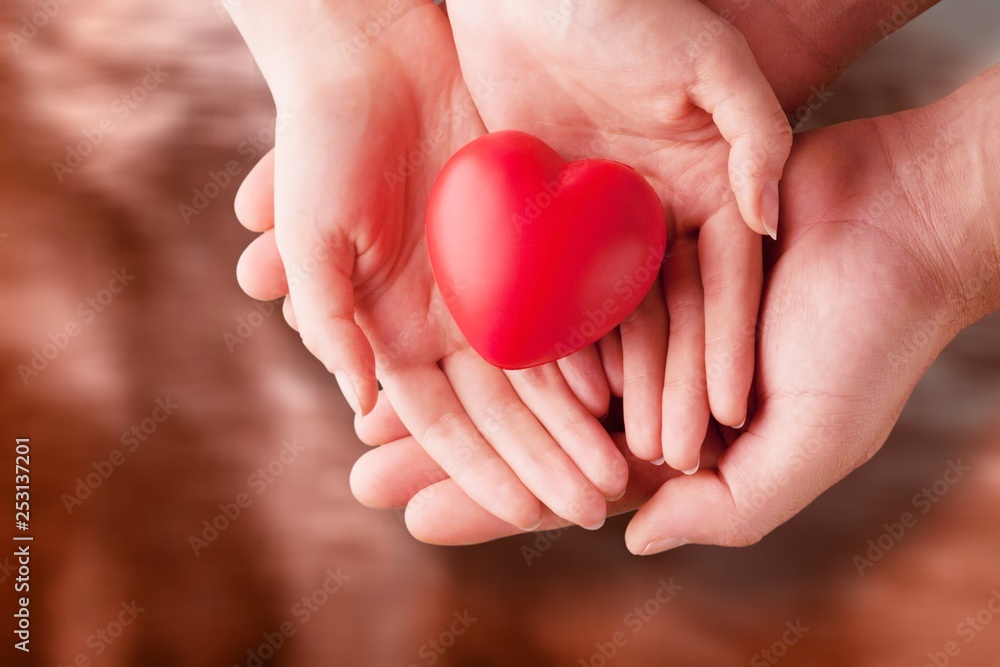Man and woman holding red heart Man and woman holding red heart