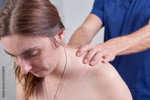 Physiotherapist doing a mobilization neck of female patient. Manual therapy.  Neurological physical examination. Osteopathy, Chiropractic photo