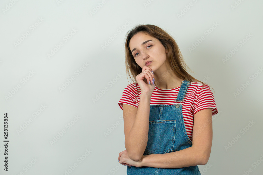 Emotional portrait of a fair-haired girl on a gray background, stormy emotions, business concept. Emotional portrait of a fair-haired girl on a gray background, stormy emotions, business concept.