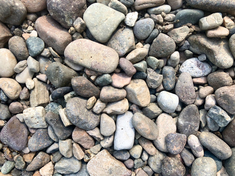 Sea stones background, little rocks, small, stones, in many shades of grey, white and blue, texture of little rocks Sea stones background, little rocks, small, stones, in many shades of grey, white and blue, texture of little rocks
