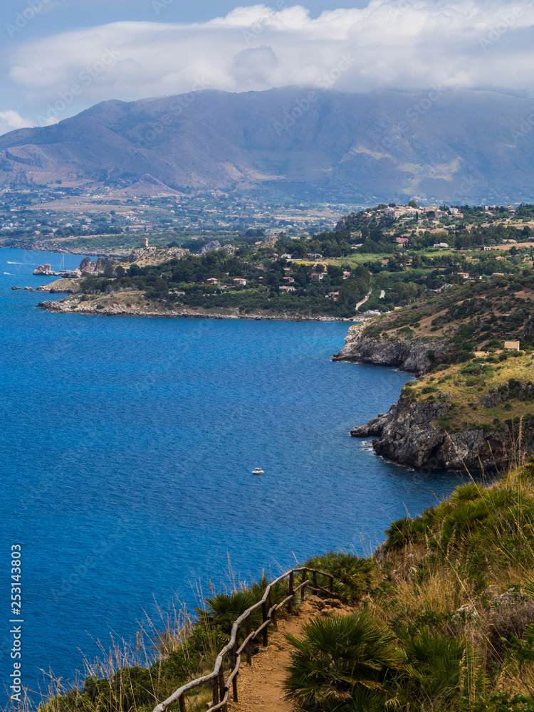 Beautiful postcard view of the Sicilian rocky coast in Italy, walking on a dirt path in the Gypsy Reserve, on the sea