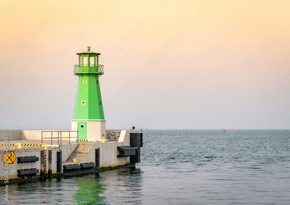 Green lighthouse at the entrance to the port of Gdańsk, Poland