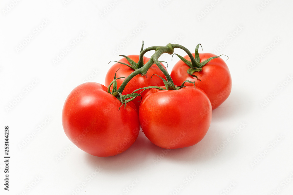 Ripe tomatoes isolated on white background. Four whole vegetables with sepals Ripe tomatoes isolated on white background. Four whole vegetables with sepals