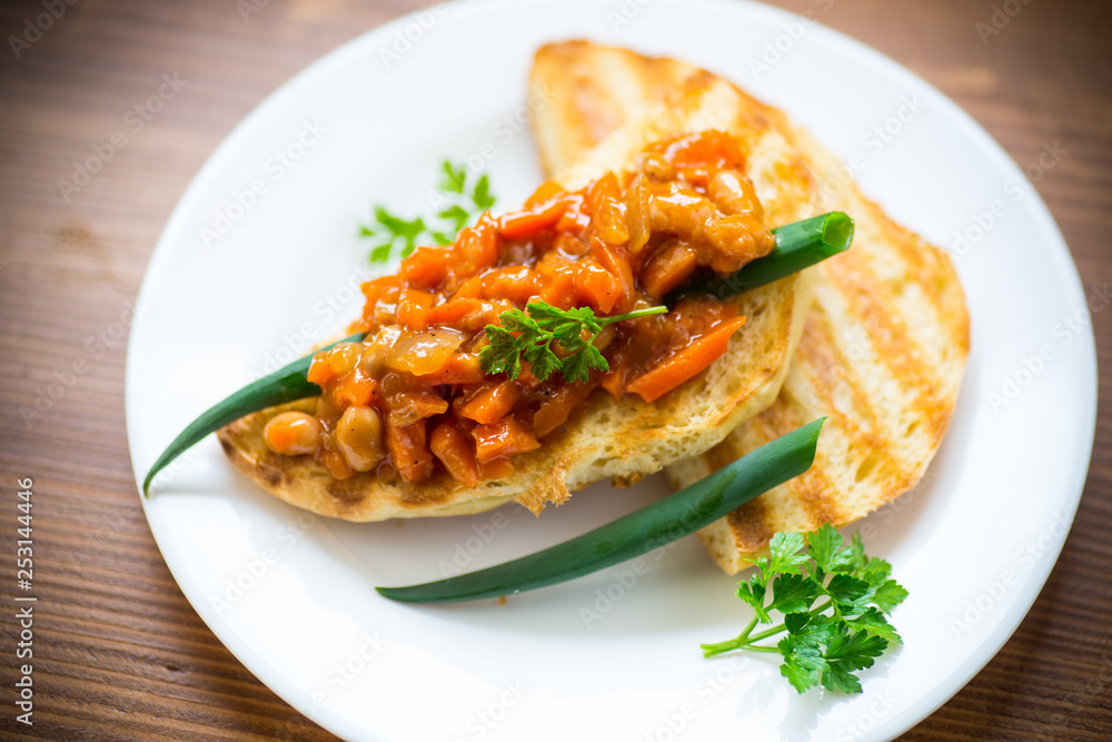 fried bread toasts with stewed beans and vegetables in a plate fried bread toasts with stewed beans and vegetables in a plate